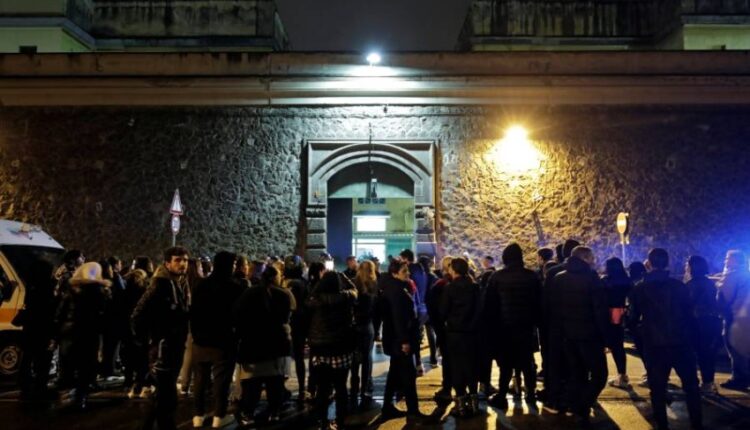Relatives of inmates gather outside Poggioreale prison in Naples